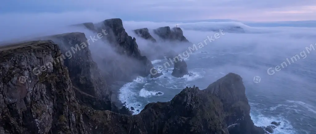 Aerial banner of a fog-bound coastline in cold twilight.